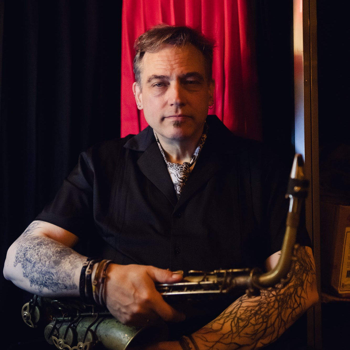 Musician Rent Romus holding a saxophone.